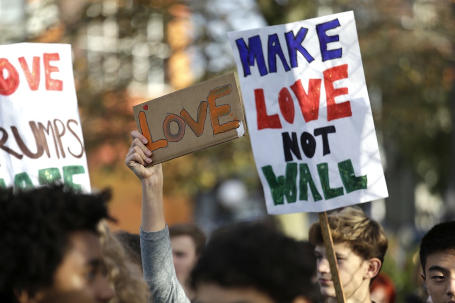 caption: Students hold up signs during a walkout to protest the election of Donald Trump as president, Monday, Nov. 14, 2016, in Seattle. A spokesman with Seattle Public Schools estimates that about 2,300 students from 14 middle and high schools participated.