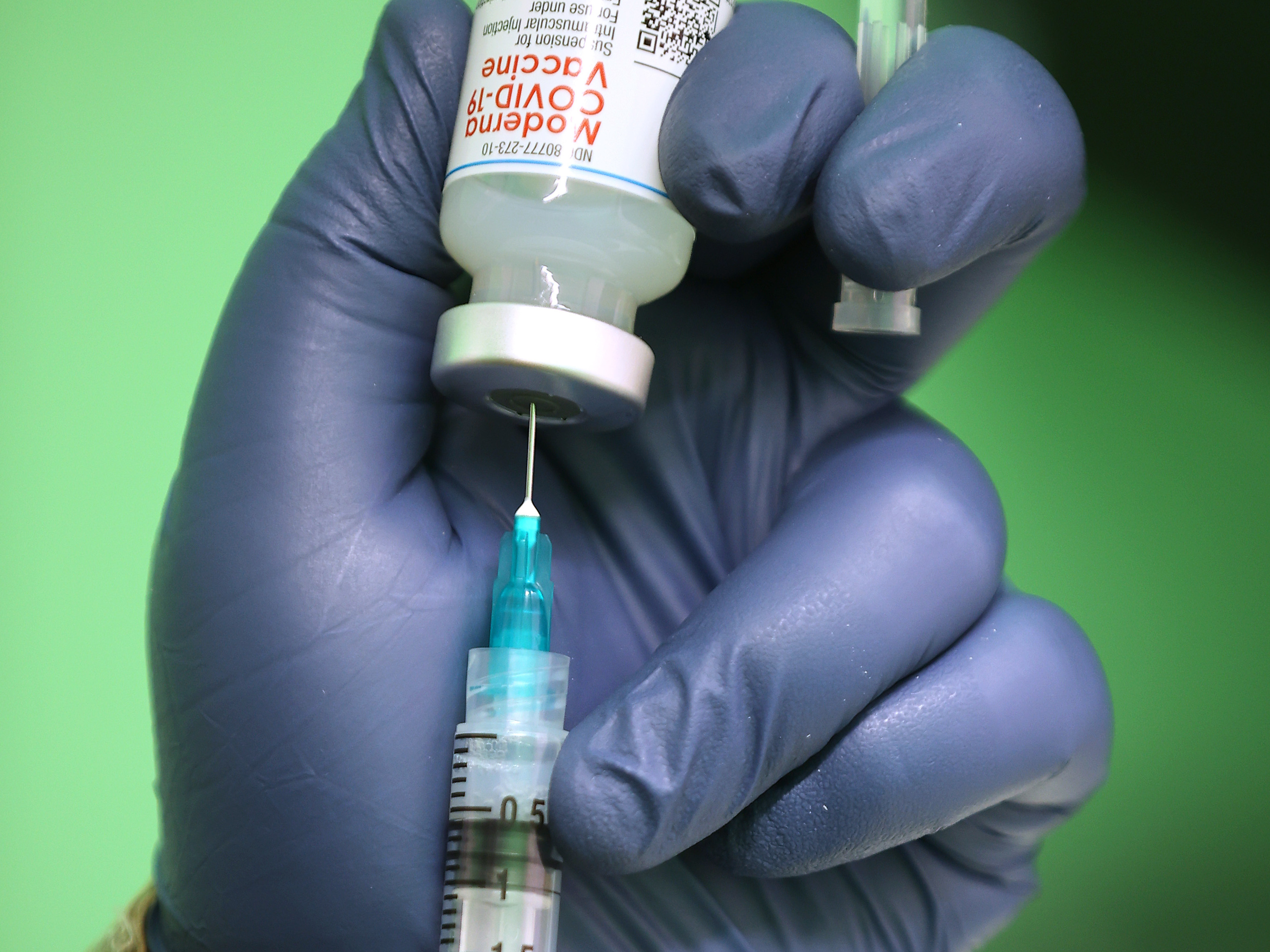 caption: Moderna says clinical trials showed its COVID-19 vaccine is effective for children from age 12 to 17, with mostly mild or moderate side effects. Here, a syringe is filled with a dose of the Moderna coronavirus vaccine in Wheaton, Md.