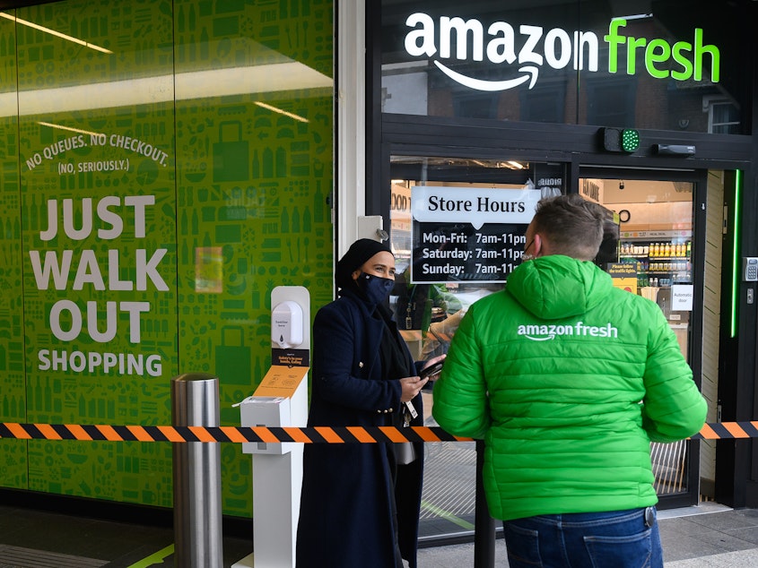 caption: The first Amazon Fresh grocery store in London opened in 2021. The company is replacing its "Just Walk Out" technology at U.S. stores with smart shopping carts, but leaving it in the U.K.