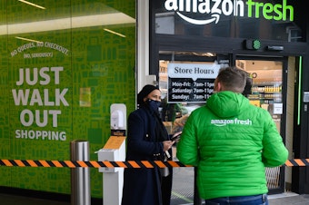 caption: The first Amazon Fresh grocery store in London opened in 2021. The company is replacing its "Just Walk Out" technology at U.S. stores with smart shopping carts, but leaving it in the U.K.
