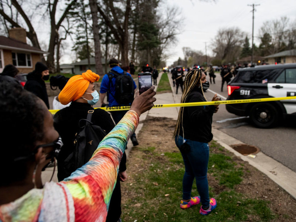caption: People gather to protest the police Sunday in Brooklyn Center, Minn., after an officer shot Daunte Wright during a traffic stop.