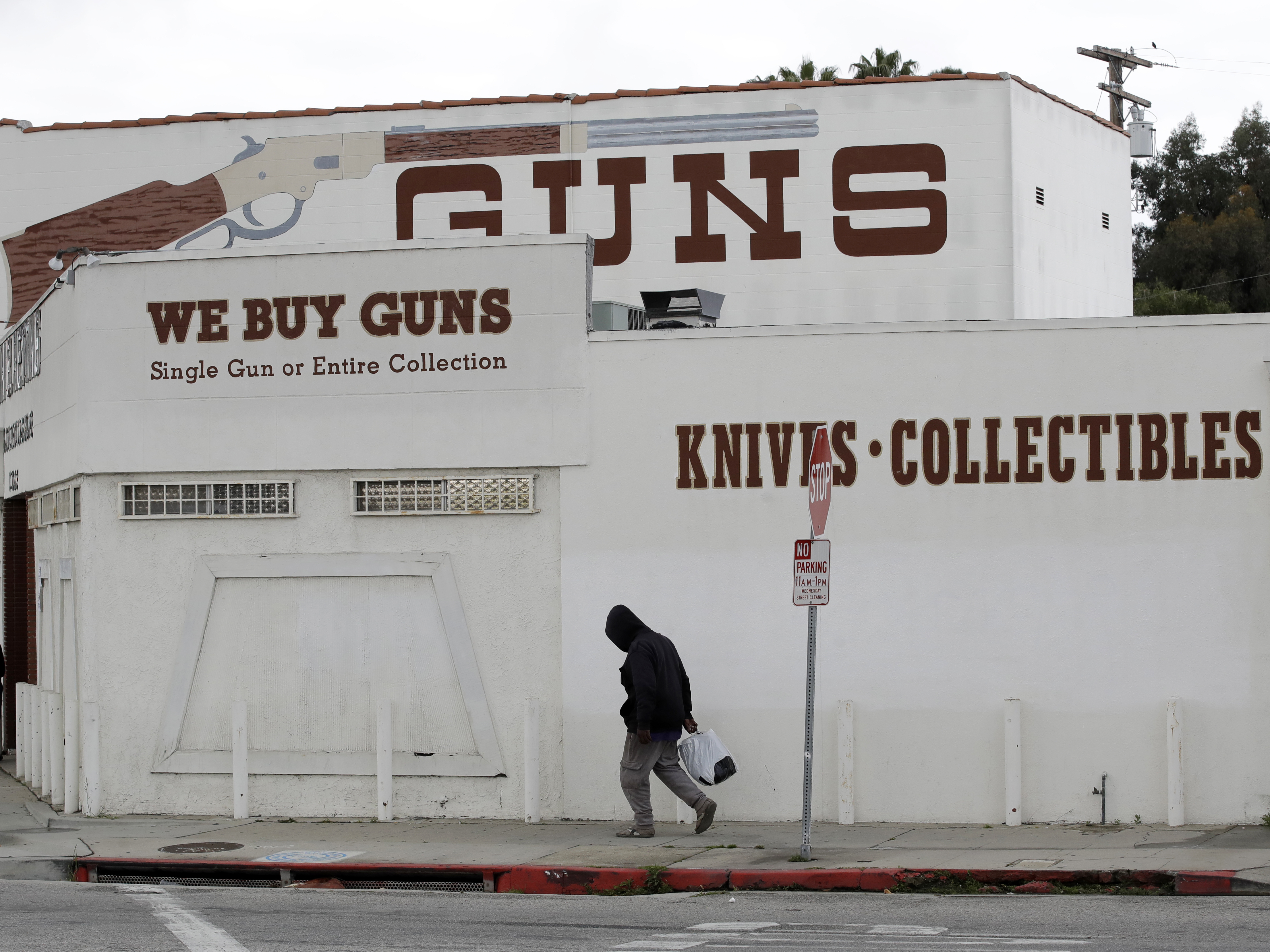 caption: Guns are advertised for sale at a shop on Tuesday in Culver City, Calif. Los Angeles County Sheriff Alex Villanueva said he would like to see gun shops shut down.