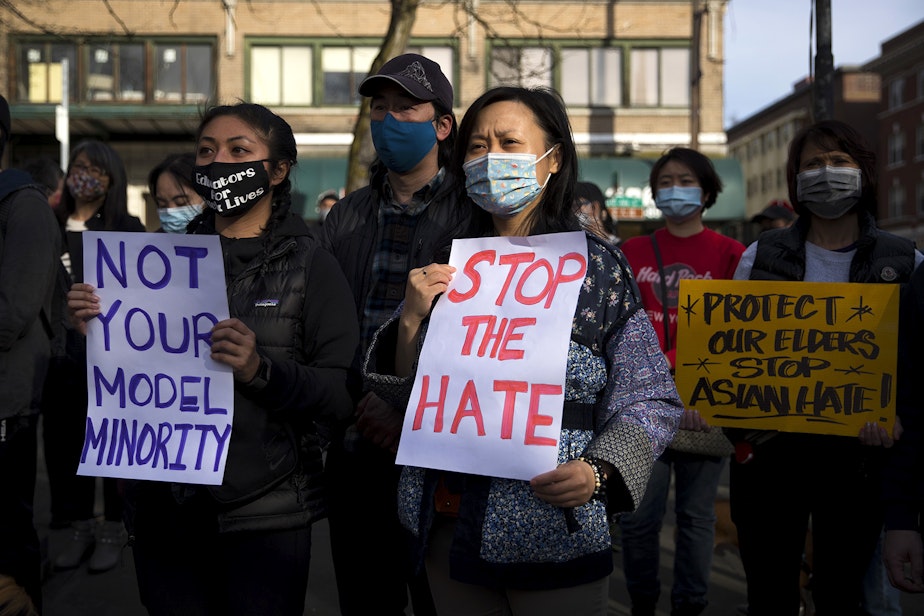 caption: Erica Nguyen, left, and Annie Zhou hold signs that read 'Not Your Model Minority' and 'Stop The Hate' while attending the 'We Are Not Silent' rally against anti-Asian hate and violence on Saturday, March 13, 2021, at Hing Hay Park in Seattle. Several days of actions are planned by rally organizers in the Seattle area following recent attacks and violence against Asian Americans and Pacific Islanders.