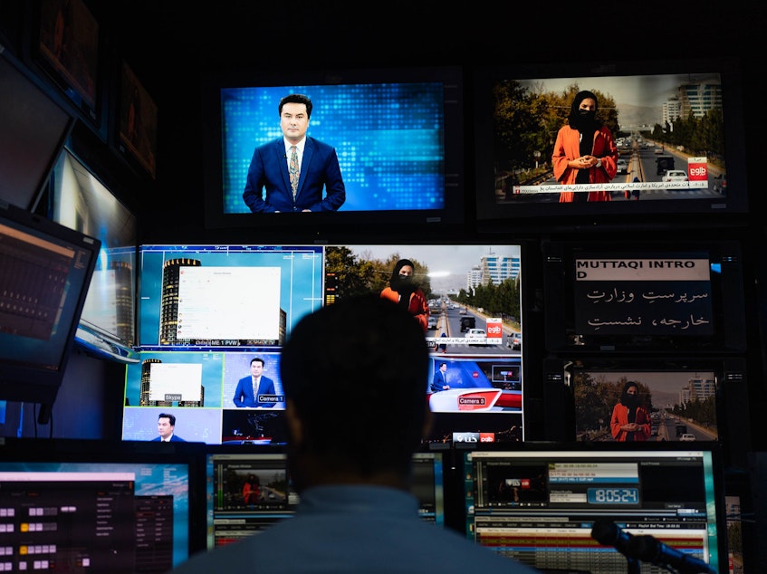 caption: A man works on the evening broadcast from TOLOnews, Afghanistan's first 24/7 new channel.