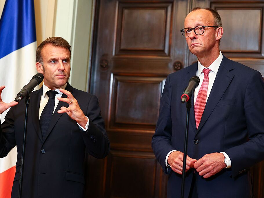 caption: German Chancellor Friedrich Merz and French President Emmanuel Macron talk to media prior to talks at Villa Borsig on July 23 in Berlin.