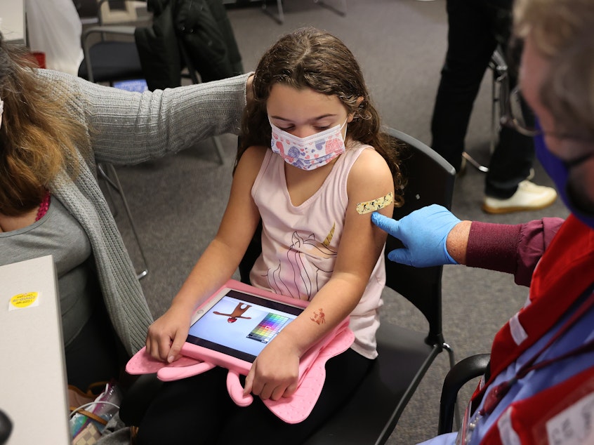 caption: A child receives the Pfizer BioNTech COVID-19 vaccine at the Fairfax County Government Center in Annandale, Va.,  in November 2021. A committee of advisers to the Food and Drug Administration recommended Wednesday that the agency expand authorization of COVID-19 vaccines to children as young as 6-months-old.