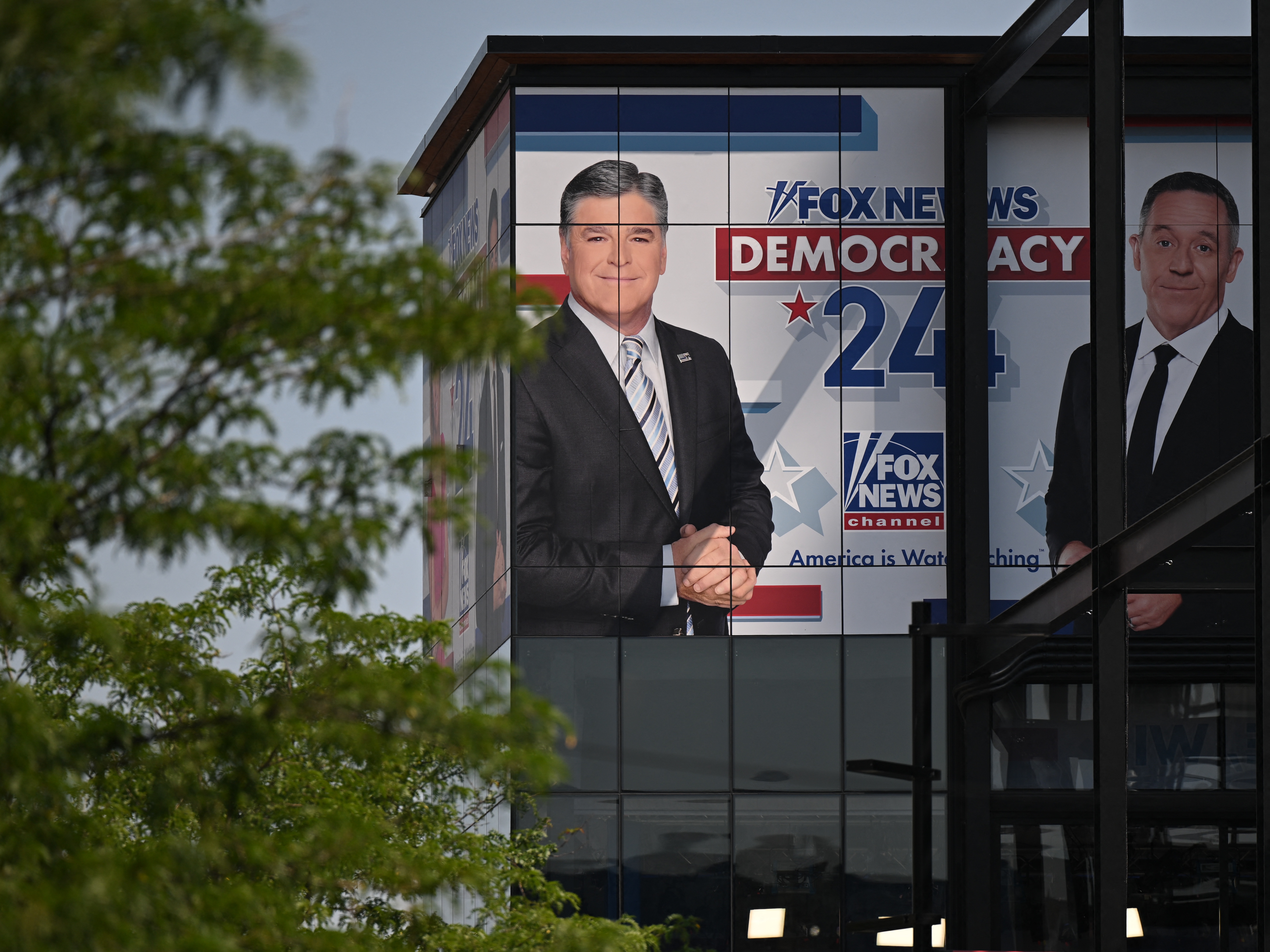 caption: Fox News Channel signage is displayed on a building near the 2024 Republican National Convention in Milwaukee. Fox scored two major legal victories within 24 hours.