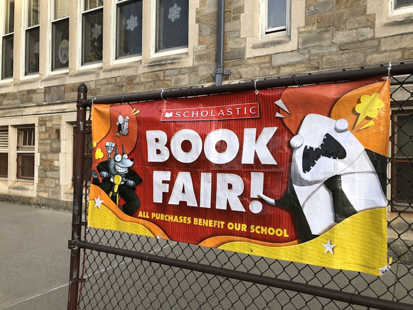 caption: A Scholastic Book Fair banner pictured outside a school in Queens, New York.