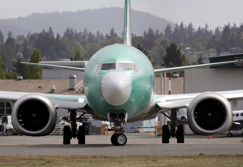 caption: FILE - In this may 8, 2019 photo, a Boeing 737 MAX 8, being built for American Airlines, makes a turn on the runway as it's readied for takeoff on a test flight in Renton, Wash. 