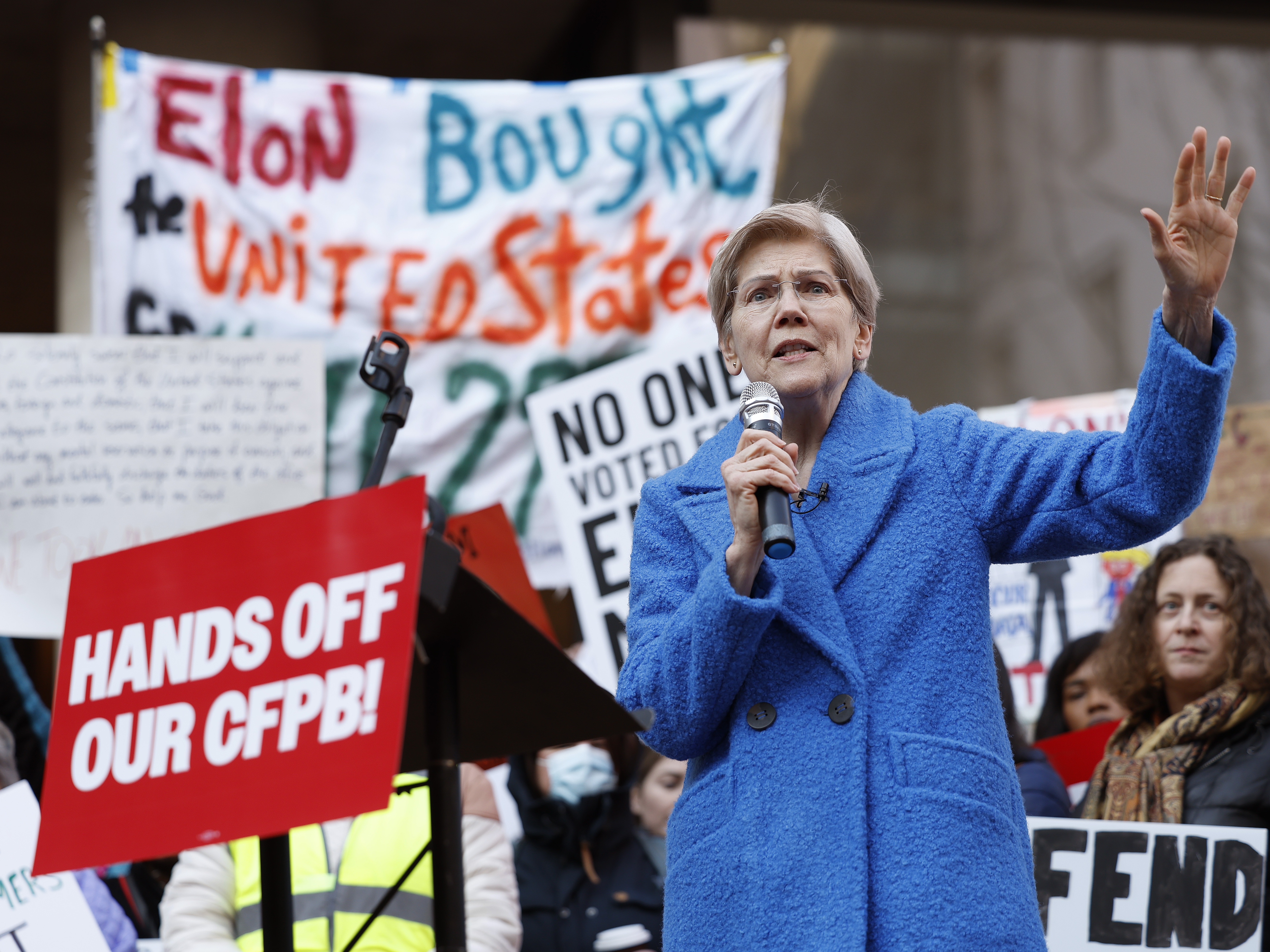 caption: Sen. Elizabeth Warren, D-Mass., speaks at a rally outside the Consumer Financial Protection Bureau in Washington, D.C., on Feb. 10, 2025. Dozens of CFPB workers were laid off on Tuesday, the agency's union said.
