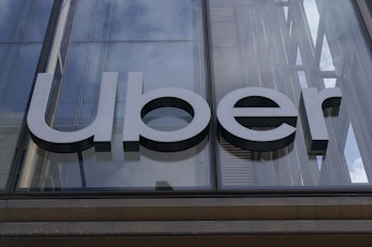 caption: An Uber sign is displayed at the company's headquarters in San Francisco on Monday.
