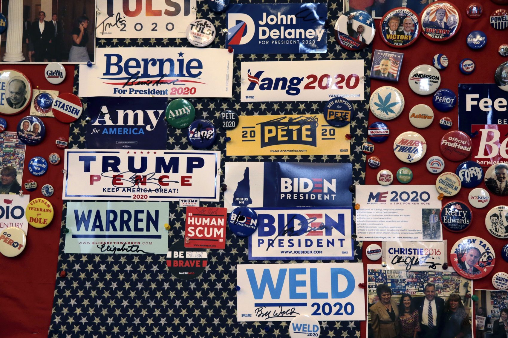 caption: Pins and bumper stickers of presidential contenders in the New Hampshire primary are displayed in the State House visitors center on Nov. 14 in Concord, N.H. (Charles Krupa/AP)