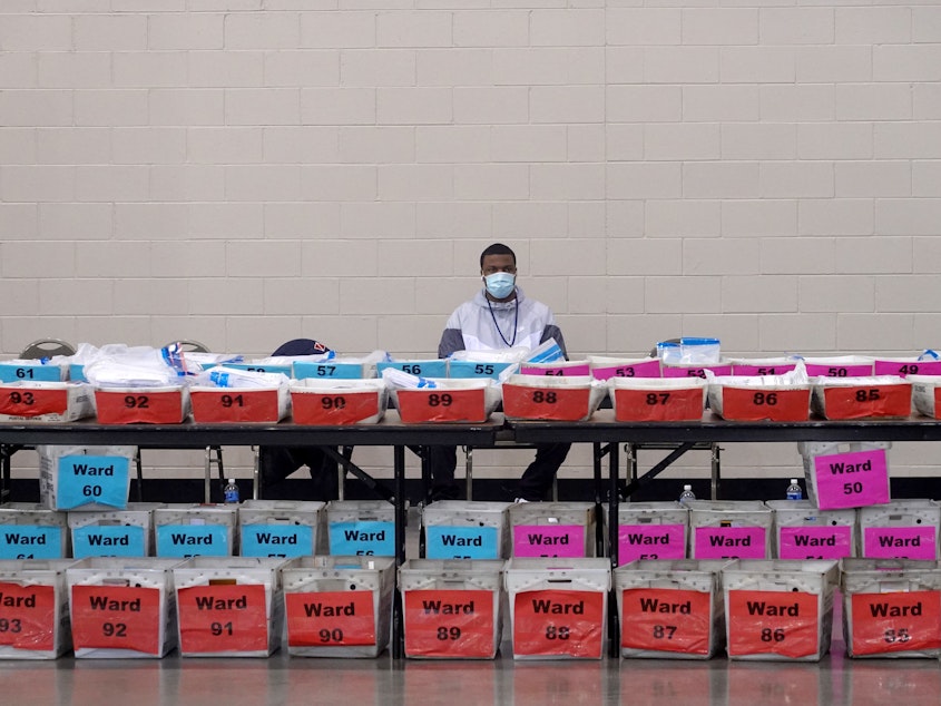 caption: An election official pauses during the ballot recount earlier this month at the Wisconsin Center in Milwaukee. Officials in Milwaukee County, where President Trump had demanded a recount, said that Joe Biden's lead increased slightly on review.