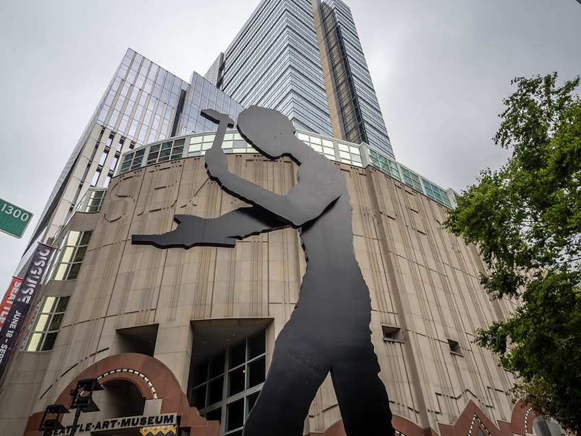 caption: "The Hammering Man" stands in front of the entrance to the Seattle Art Museum in downtown Seattle. 