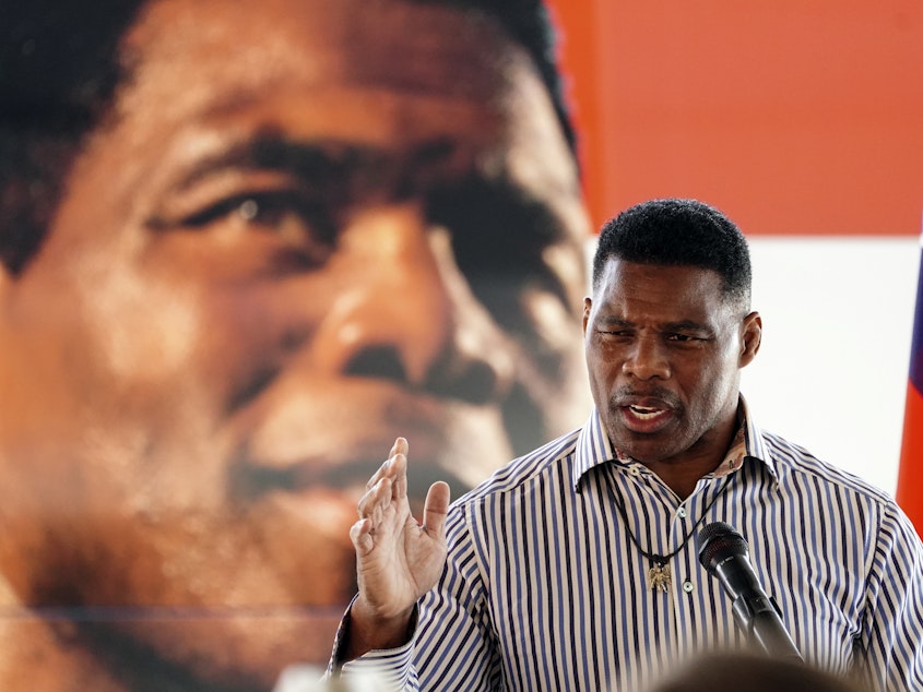 caption: Republican candidate for U.S. Senate Herschel Walker speaks during a campaign stop in Dawsonville, Ga., Tuesday, Oct. 25, 2022.