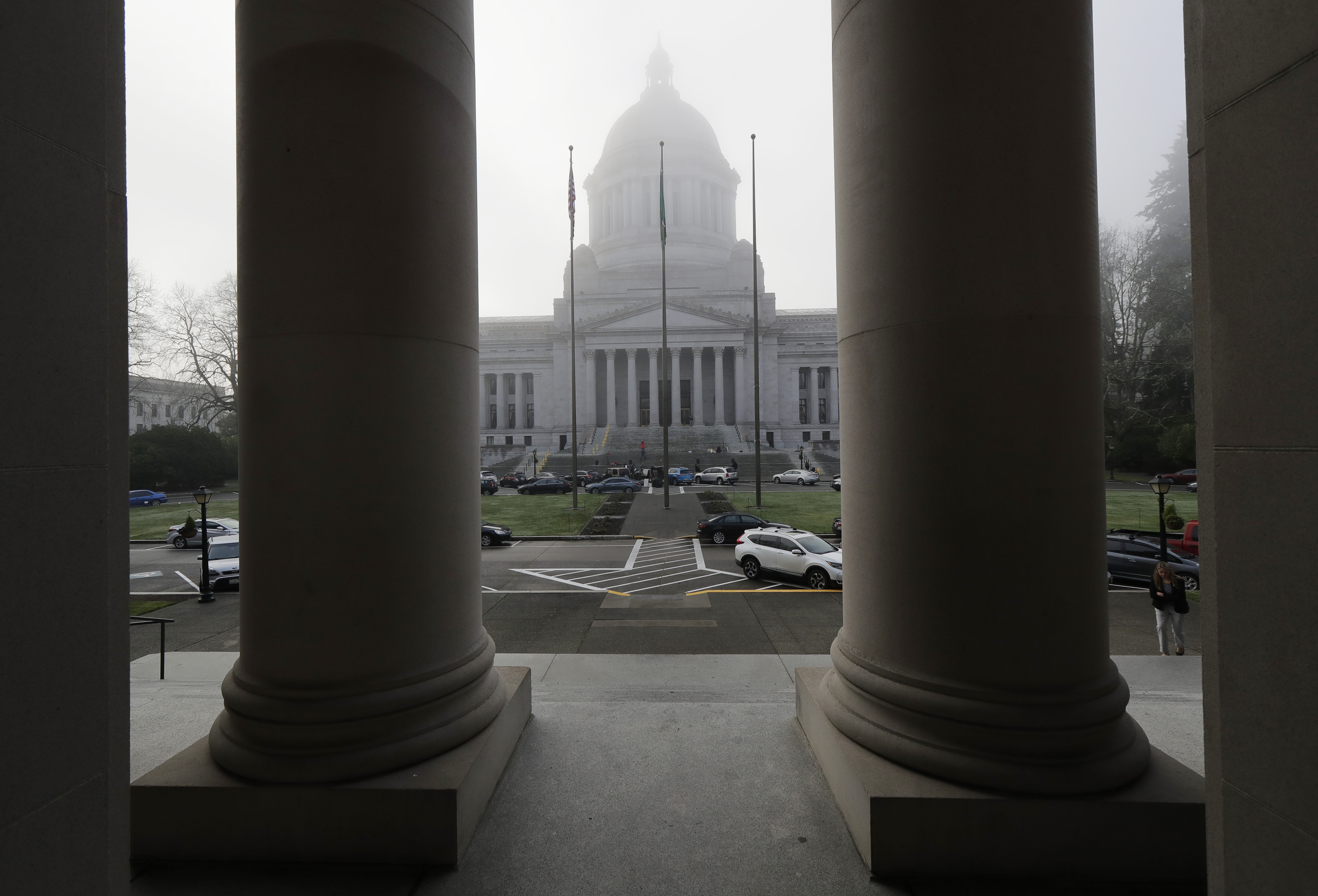 caption: The Legislative Building is viewed in a light morning fog through the columns of the Temple of Justice, Monday, Jan. 14, 2019, at the Capitol in Olympia, Wash., on opening day of the Washington Legislature. 