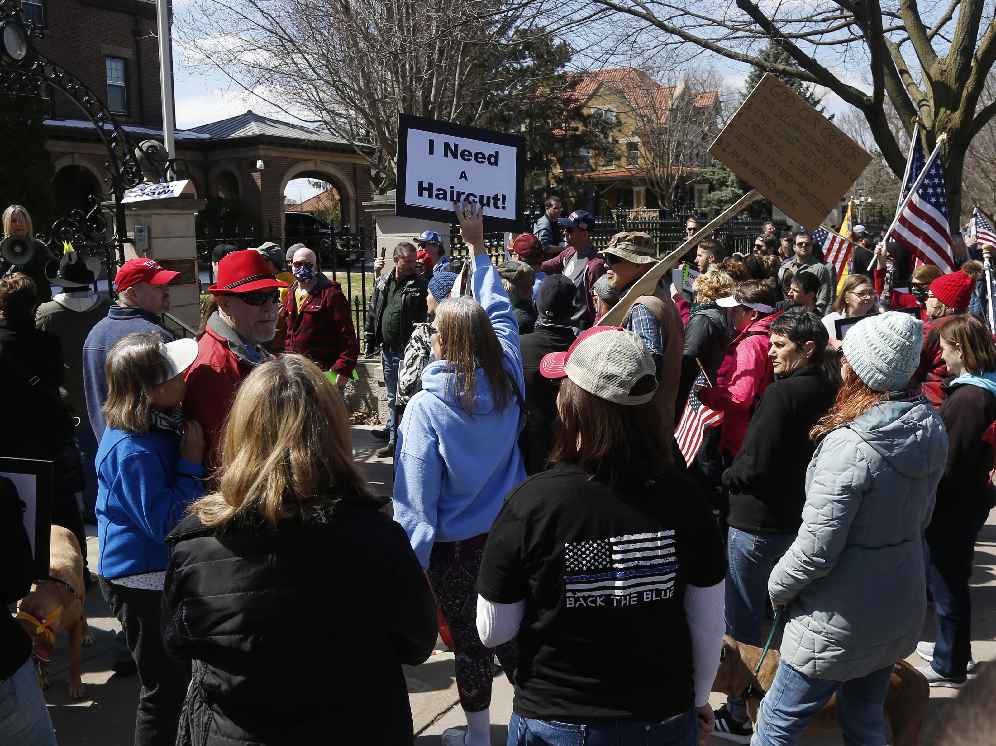 caption: Protesters gather outside Minnesota Gov. Tim Walz's official residence in St. Paul on Friday, calling for him to loosen stay-at-home restrictions imposed because of the coronavirus.