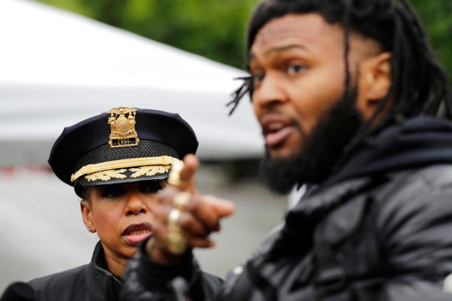 caption: Seattle Police Chief Carmen Best, left, listens to activist Raz Simone as they talk near a plywood-covered and closed Seattle police precinct Tuesday, June 9, 2020, in Seattle, following protests over the death of George Floyd. Floyd. 