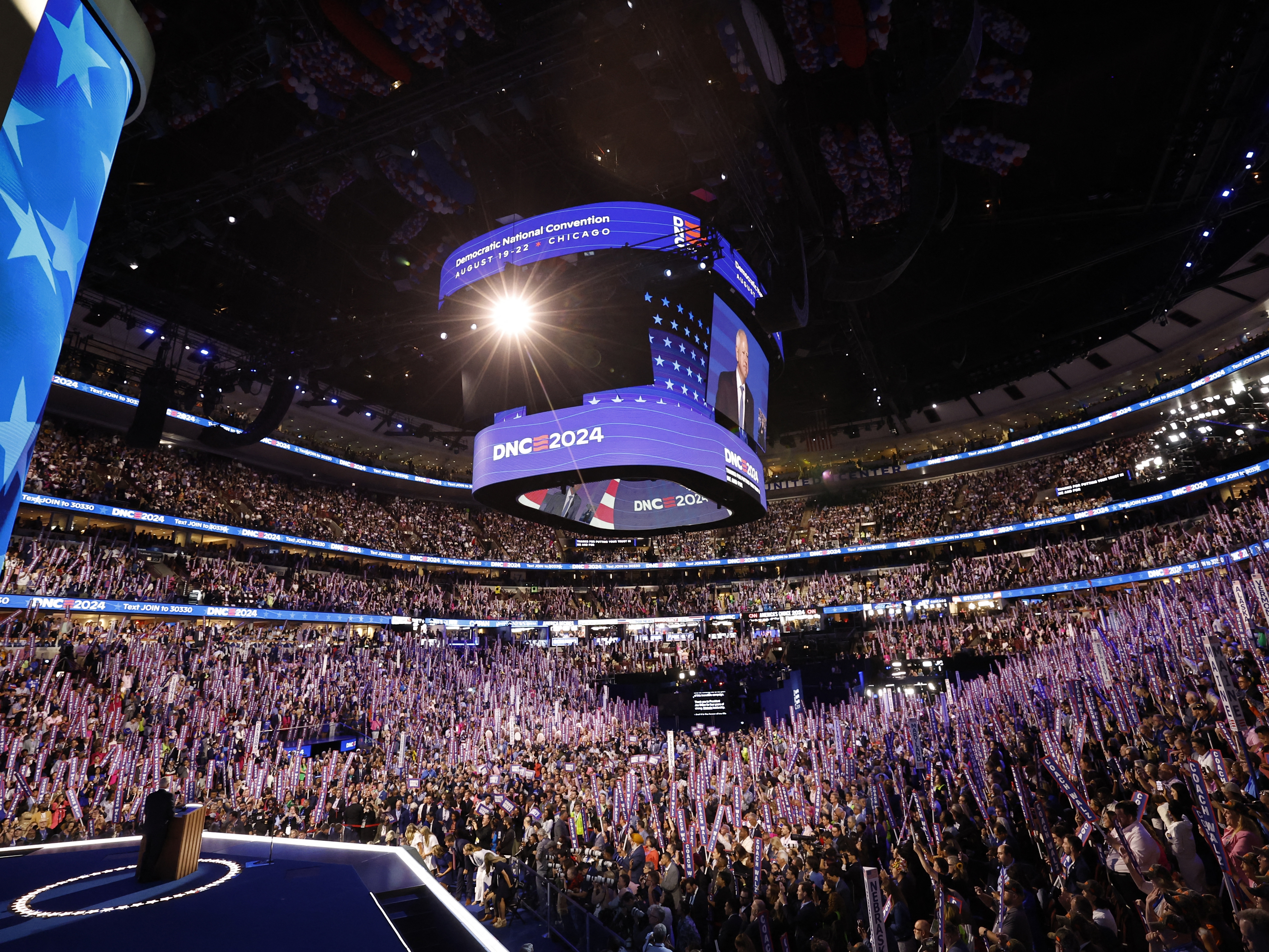 caption: Attendees wave "Coach Walz" signs as Minnesota Governor and 2024 Democratic vice presidential candidate Tim Walz speaks on the third day of the Democratic National Convention in Chicago. Tim Walz formally accepted his nomination to be the Democratic Party's vice presidential candidate in a keynote address on August 21 at the party's convention, calling it "the honor of my life."