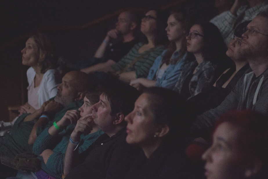 caption: An audience watches a film at the Seattle Deaf Film Festival in 2016. The festival is held every two years and features authentic representations of the Deaf and Hard of Hearing community. 