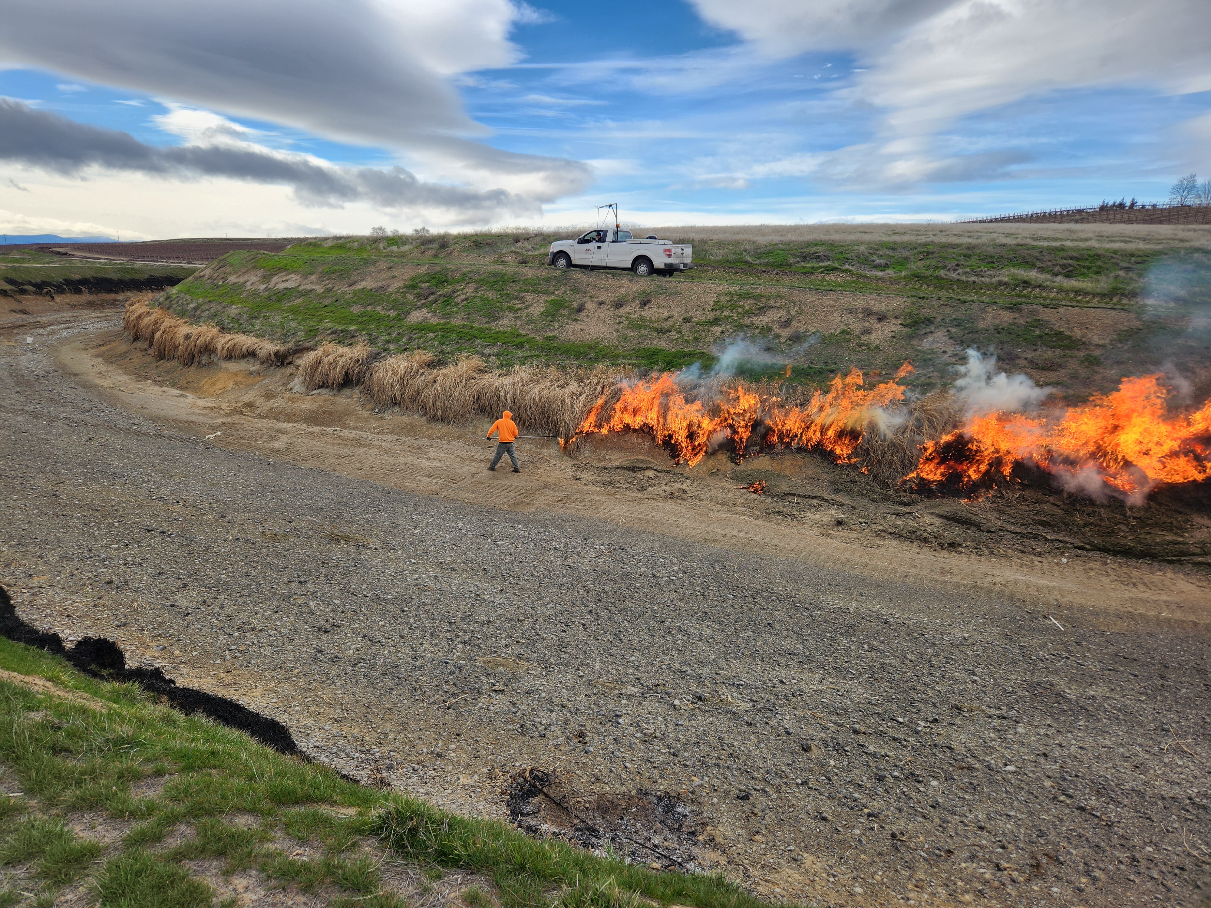 caption:  Workers clear canals of debris in preparation for spring irrigation season in the Roza Irrigation District.