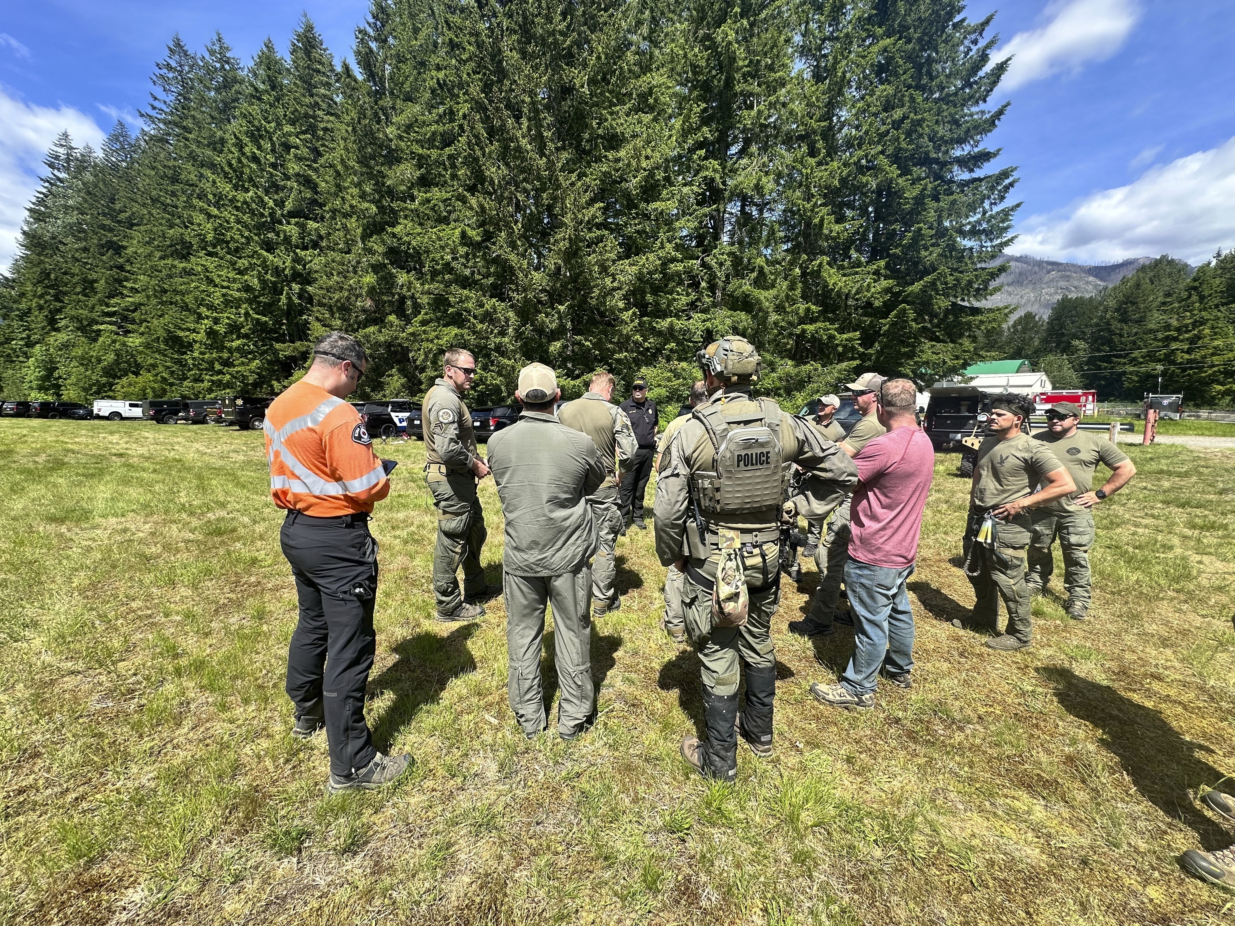 caption: In this handout photo provided by the Snohomish County Sheriff's Office deputies participate in the search for Travis Decker, at an undisclosed location in Washington state, Friday, June 6, 2025.