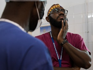 caption: Orthopedic surgeon Kebba Marenah and his team get ready to perform knee surgery on a 14-year-old at the Edward Francis Small Teaching Hospital in Banjul, the capital of Gambia. The country struggles with a lack of access to sufficient pain medications.