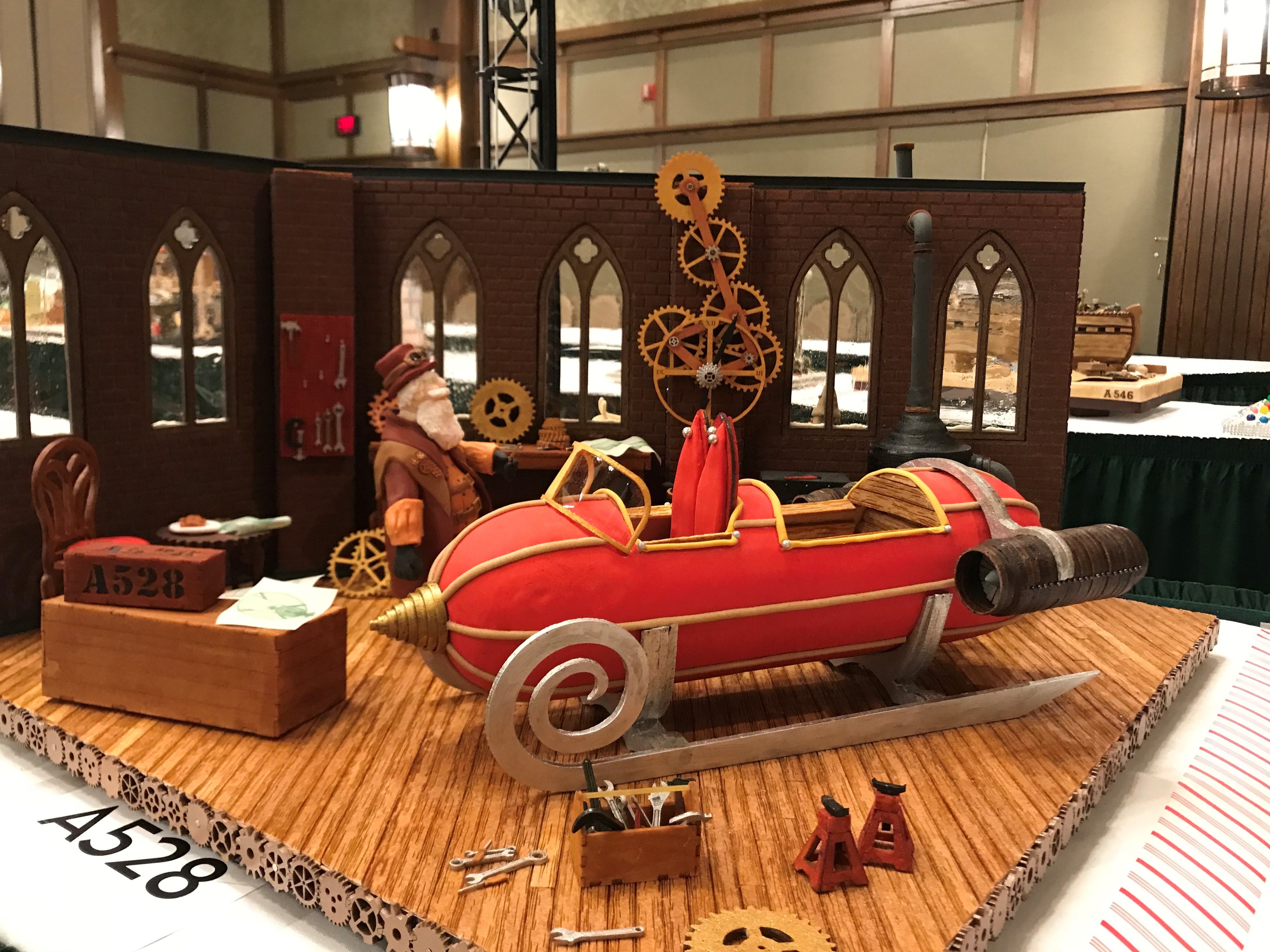 caption: For this year's grand prize winner, the judges were impressed by the intricate, working gingerbread gears of the clock inside Santa's workshop.