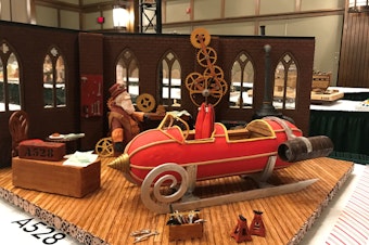 caption: For this year's grand prize winner, the judges were impressed by the intricate, working gingerbread gears of the clock inside Santa's workshop.
