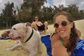 caption: Mary Finley, Travis Sherman and Tonka at the beach. 'I'm fearful of the world that we are making for ourselves,' Travis said. 'That's why I don't want to have children.'