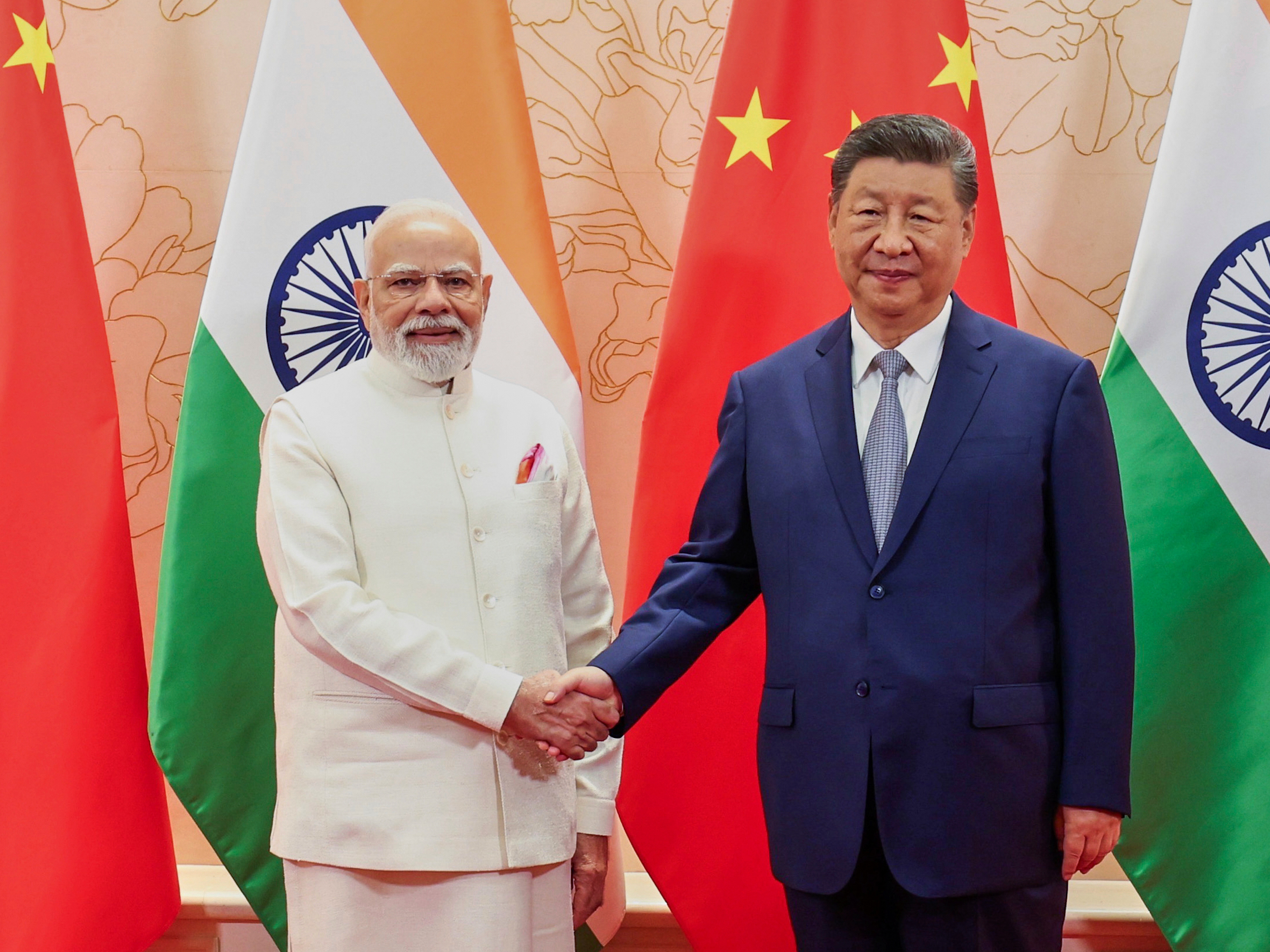 caption: In this photo provided by Indian Prime Minister's Office, Indian Prime Minister Narendra Modi, left, and Chinese President Xi Jinping shake hands before their meeting on the sidelines of the Shanghai Cooperation Organization (SCO) summit in Tianjin, China Sunday, Aug. 31, 2025.