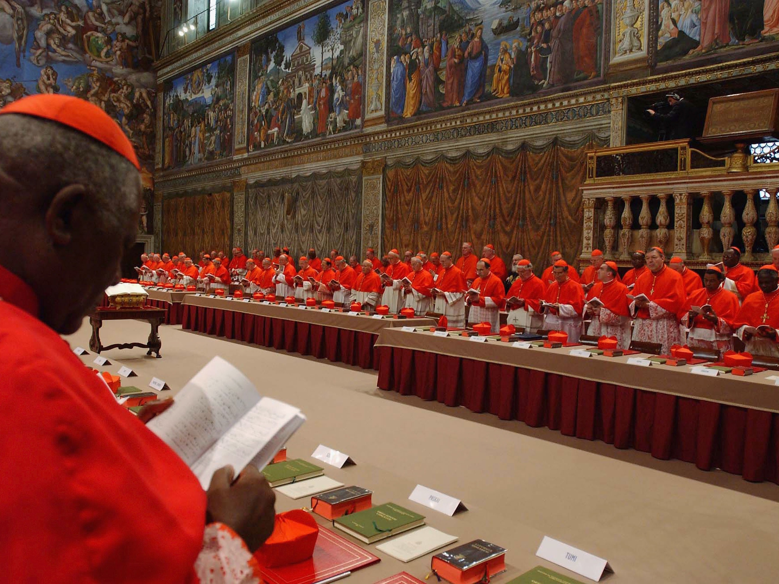 caption: Cardinal electors attend the papal conclave inside the Sistine Chapel on April 18, 2005.