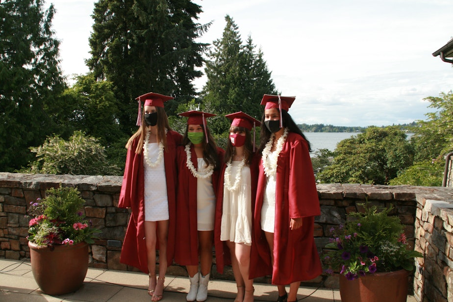 caption: From left to right, Elizabeth Gottesman, Annie Poole, Isabel Funk, and Lila Shroff pose for a traditional graduation photo— but with masks on June 8, 2020. Poole wears a Black Lives Matters mask— a testament to the complex turmoil of the country high school seniors find themselves graduating into.