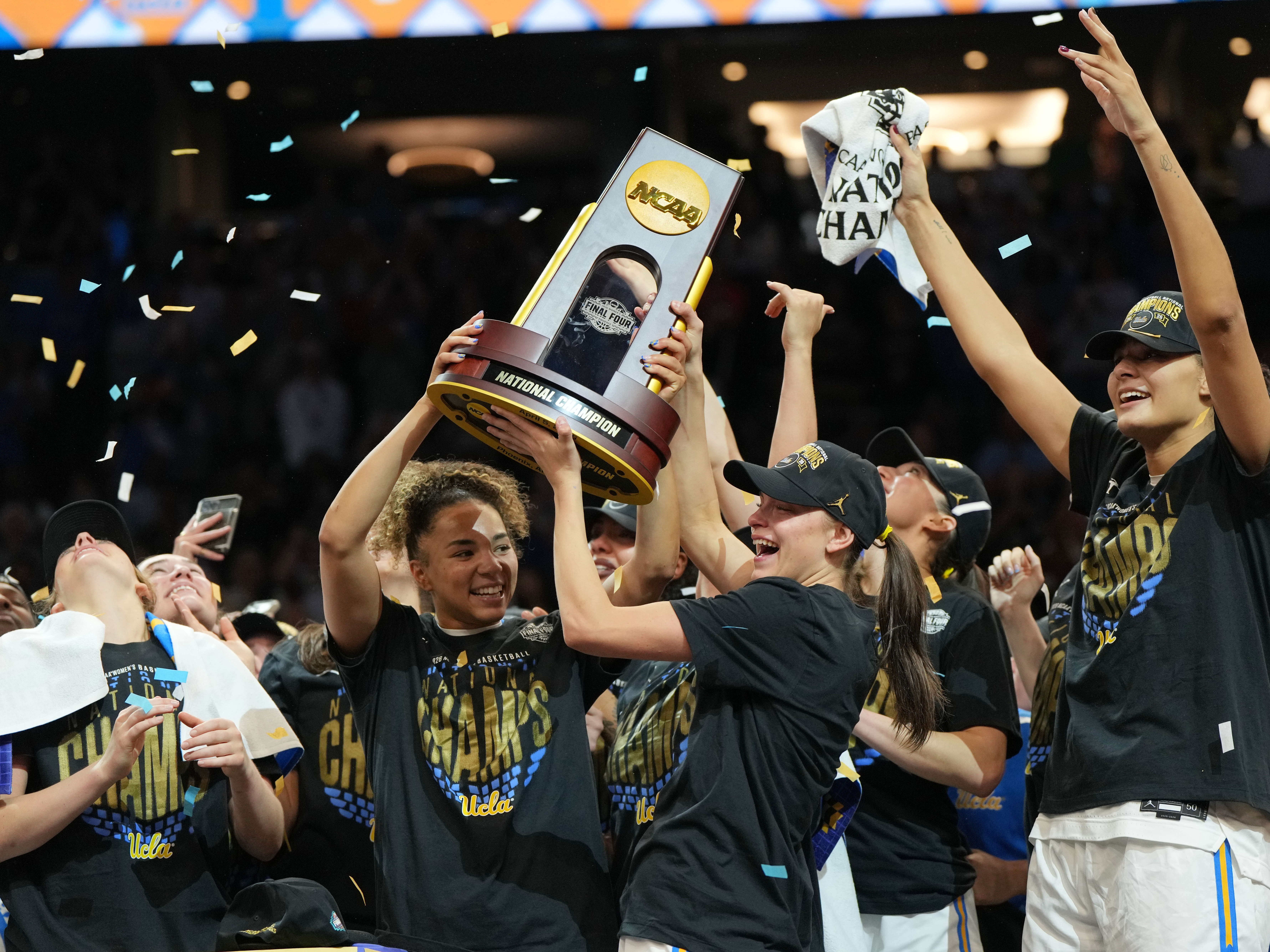 caption: UCLA players celebrate after defeating South Carolina in the women's National Championship Final Four NCAA college basketball tournament game on Sunday in Phoenix.