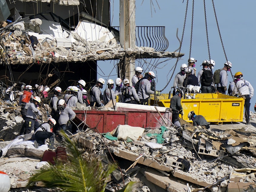 caption: President Biden plans to visit the Champlain Towers condo collapse later this week.