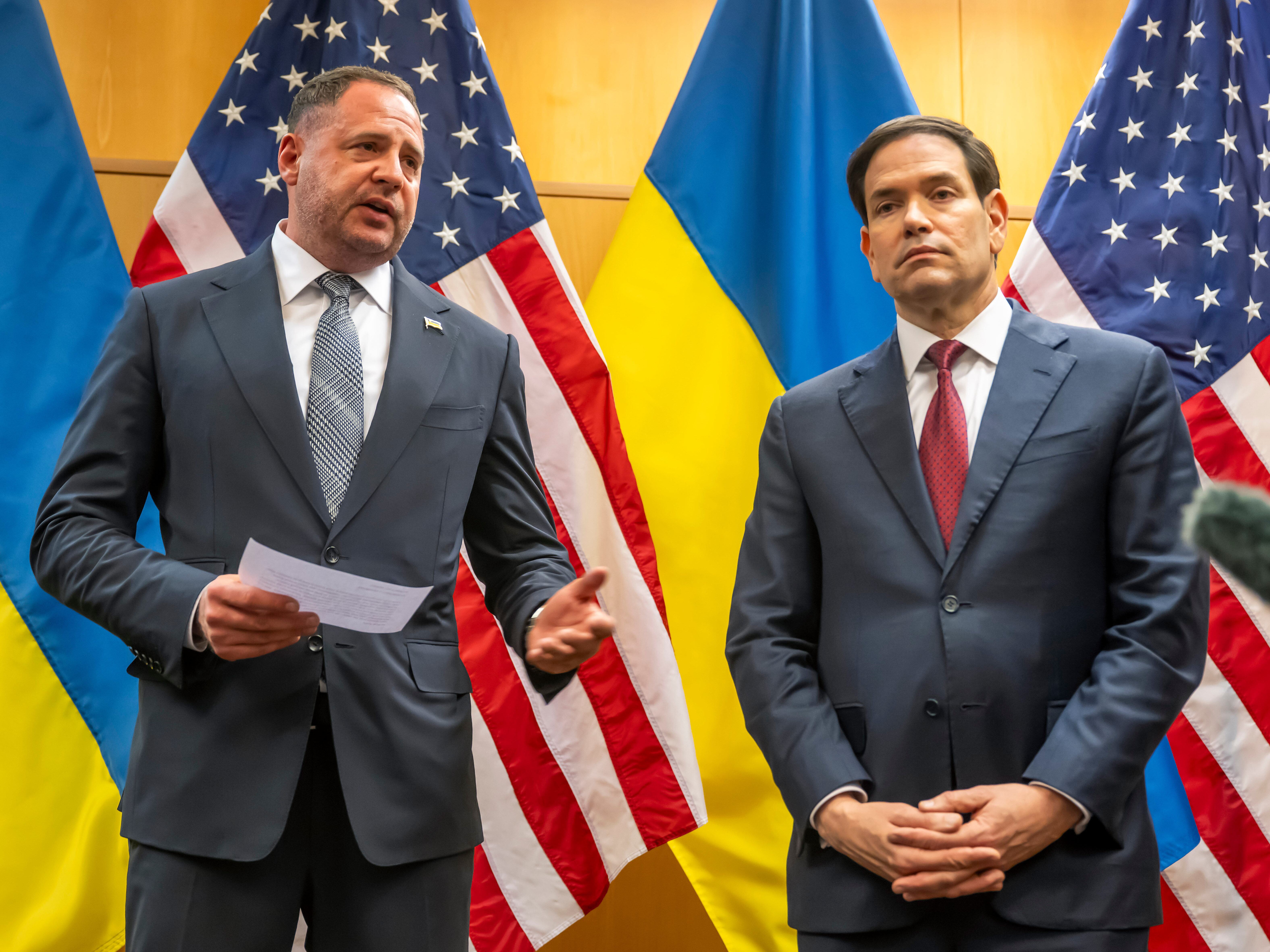 caption: Head of the Office of the President of Ukraine Andriy Yermak, second right, and U.S. Secretary of State Marco Rubio talk to the press as their consultations continue at the U.S. Mission to International Organizations in Geneva, Switzerland, Sunday, Nov. 23, 2025.