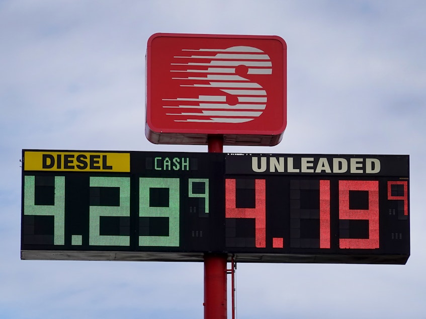 caption: Gas prices are displayed on a sign at a gas station on March 3, 2022 in Hampshire, Il.