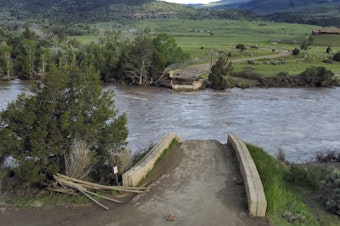 caption: A washed out bridge shown along the Yellowstone River Wednesday, June 15, 2022, near Gardiner, Mont.