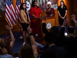 caption: US Representatives Rashida Tlaib (D-MI), Ayanna Pressley (D-MA), Ilhan Omar (D-MN) and Alexandria Ocasio-Cortez (D-NY) hold a press conference at the US Capitol in Washington, DC on July 15, 2019 to address remarks made by President Donald Trump.