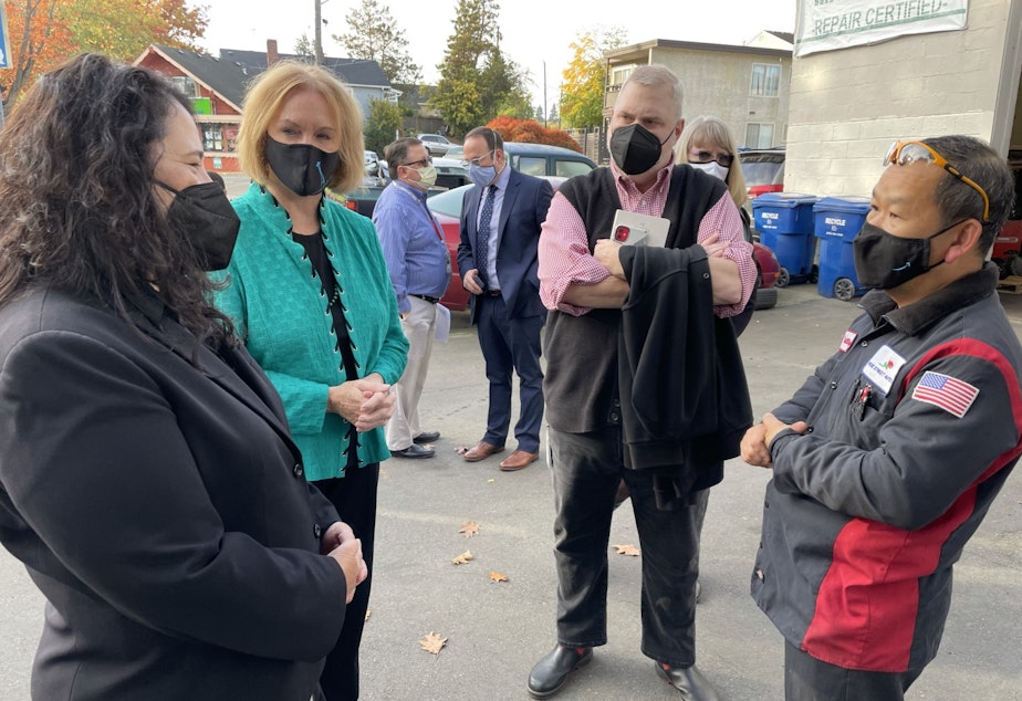caption: SBA Administrator Isabelle Guzman (L) and Seattle Mayor Jenny Durkan (2nd from L) speak with Philip Nguyen, owner of Rose Street Auto Repair
