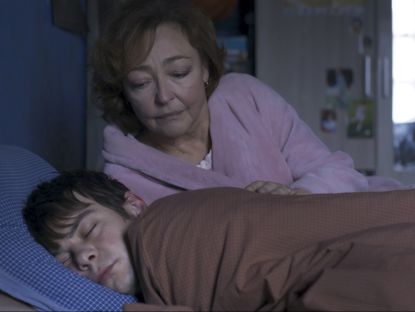 caption: Jérémie (Félix Kysyl) stays with the newly widowed Martine (Catherine Frot) in the French thriller <em>Misericordia</em>.