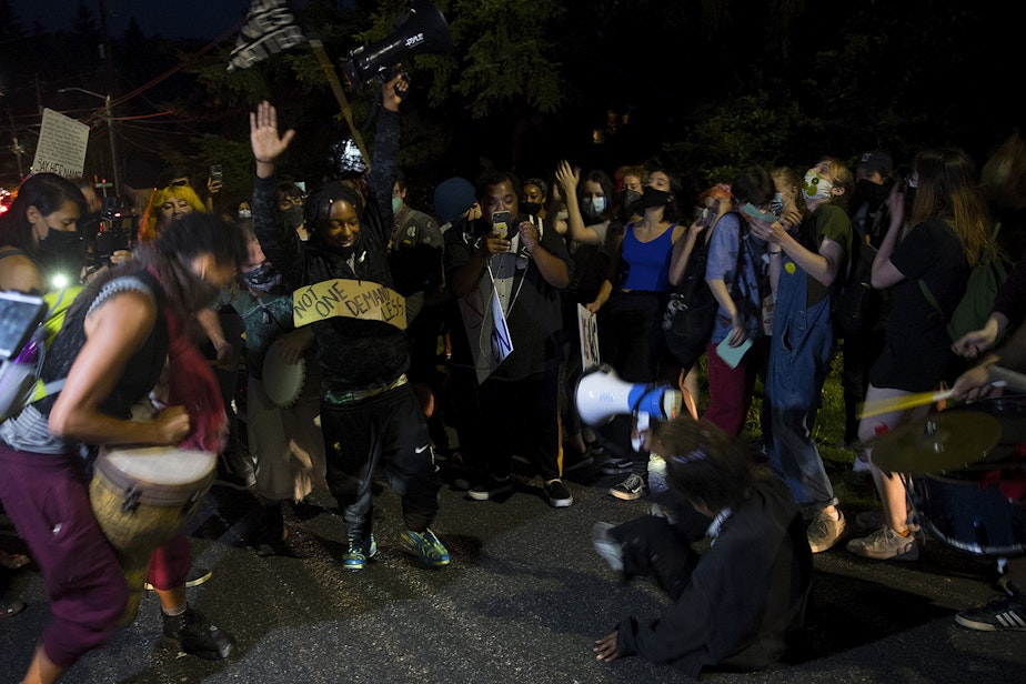 caption: The Everyday March stops to dance while heading toward Seattle City Councilmember Debora Juarez's home in an effort to have a dialogue about racial justice and police brutality on Tuesday, August 4, 2020, in the Olympic Hills neighborhood of Seattle. "It is on us," said organizer Tealshawn Turner. "It is our duty, our obligation, our responsibility to come out here and stand up for the next generation. You have to speak life into these children."