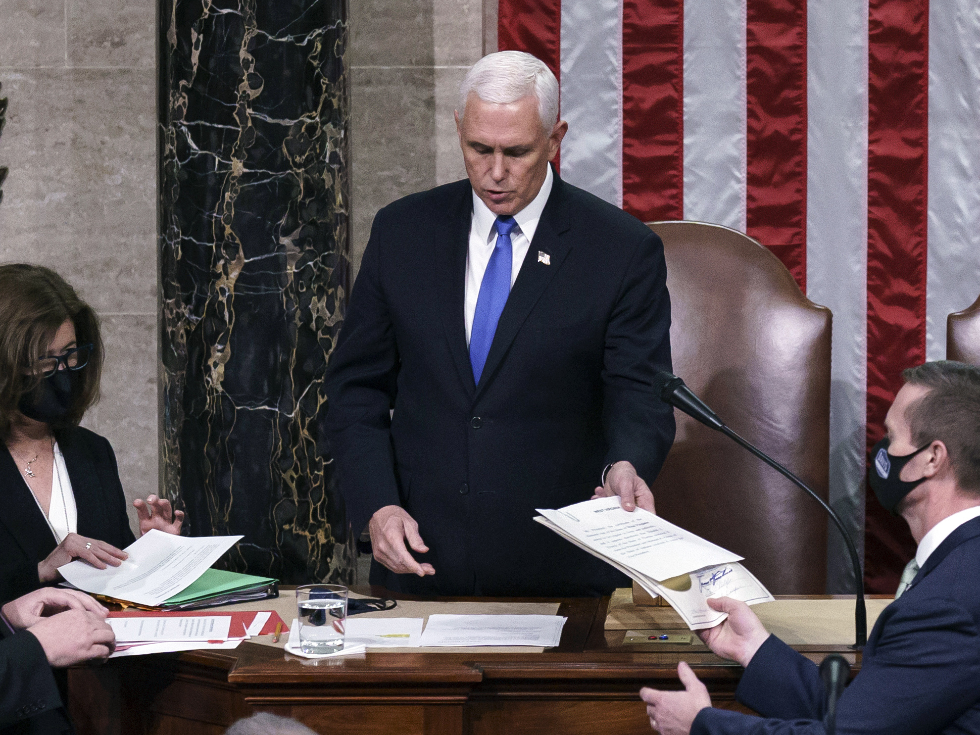 caption: Proposed changes to the Electoral Count Act would clarify the vice president's role in counting states' electoral votes. Here, then-Vice President Mike Pence is seen in the House chamber early on Jan. 7, 2021, to finish the work of the Electoral College after a mob loyal to President Donald Trump stormed the Capitol.