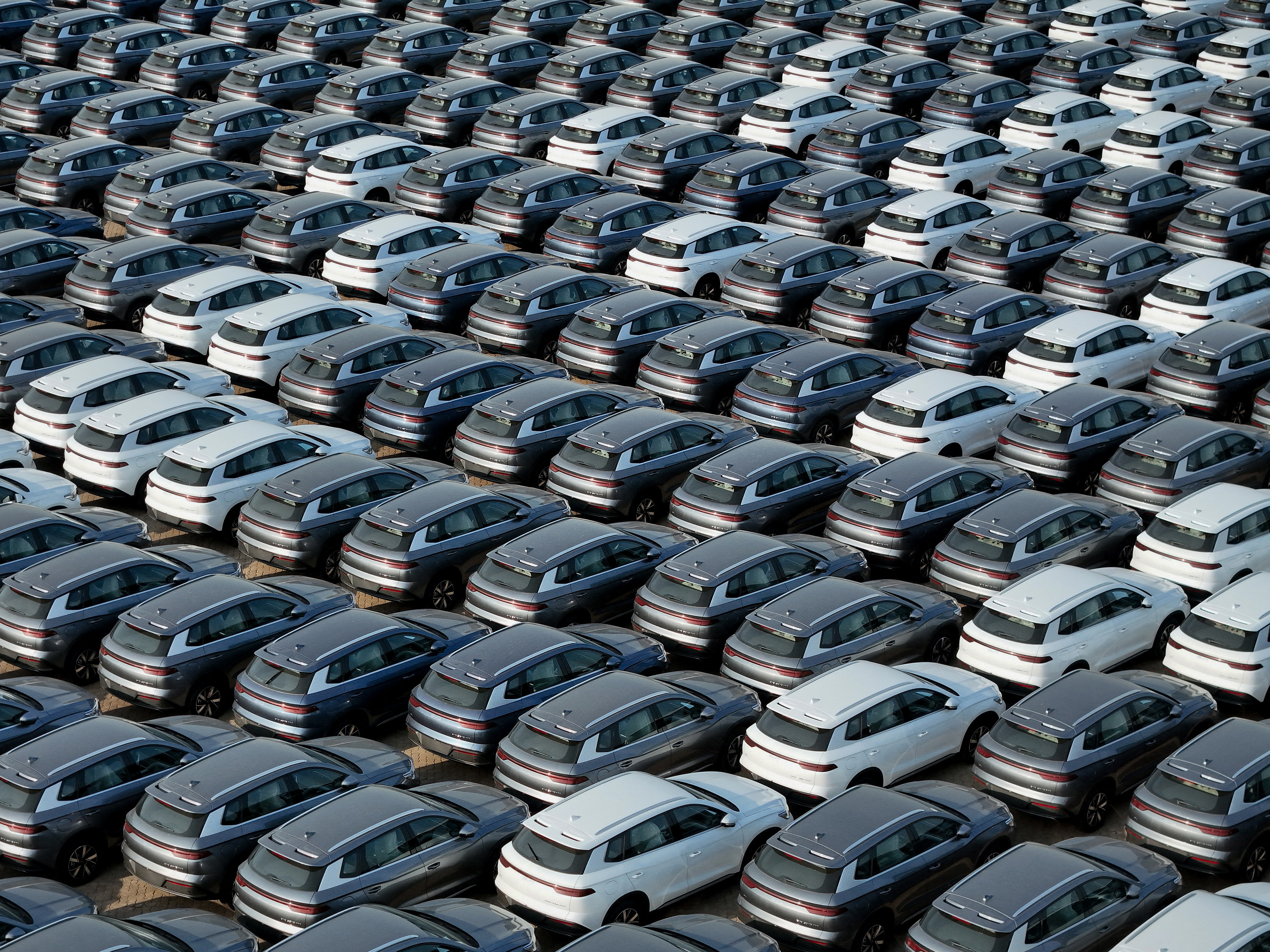 caption: BYD electric cars wait to be loaded onto a ship at a port in Yantai, China, on April 18. China has rapidly become a major auto exporter, but tariffs have kept cheap Chinese EVs out of the U.S. market — so far.