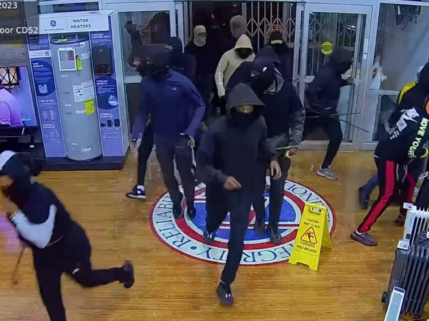 caption: An image from security camera footage shows alleged thieves breaking into a P.C. Richard & Son appliance store in Philadelphia in late September.