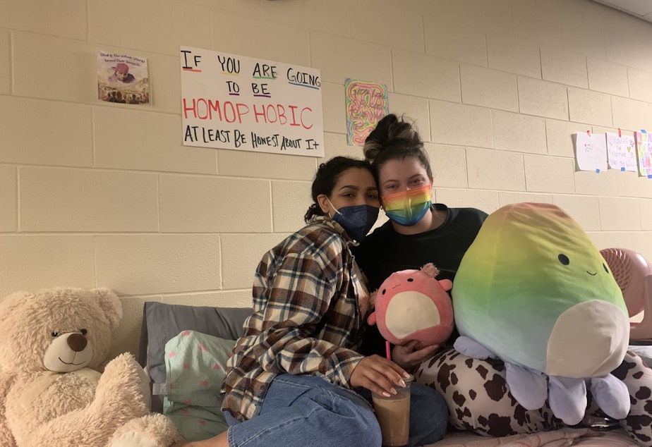 caption: Lia Harper(left) and her roommate hangout during the sit-in. Harper is currently in a play on campus, and says when she's not in class or performing, she's at the sit-in. "Your employer should have no right to know what you're doing in your house and your own sheets," Harper said.
