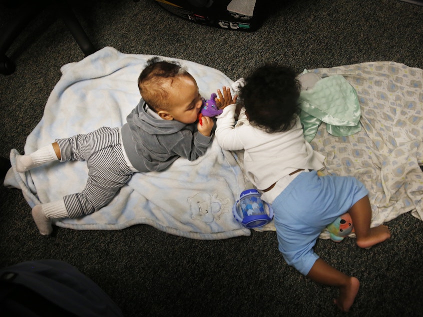 caption: Two babies play during Tara Register's Saturday group for teen moms. "Don't worry if they make noise or cry," she says. "That's OK. They're just being babies!"