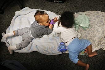 caption: Two babies play during Tara Register's Saturday group for teen moms. "Don't worry if they make noise or cry," she says. "That's OK. They're just being babies!"
