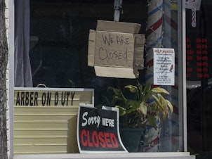 caption: Closed signs are seen Wednesday in businesses in Milwaukee. The coronavirus pandemic has left millions out of work.