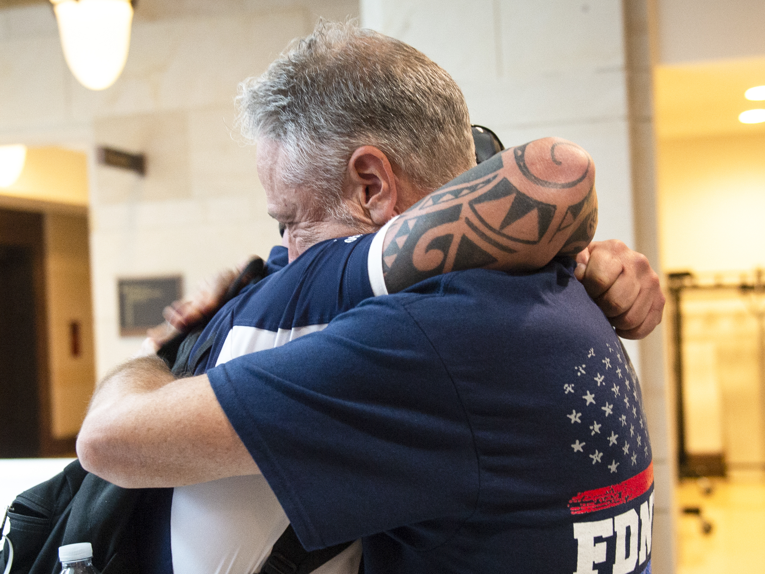 caption: Sept. 11 first responder John Feal, left, and Jon Stewart, former host of <em>The Daily Show</em>, hug after the Senate passed a bill for extending the September 11th Victim Compensation Fund in Washington on Tuesday.